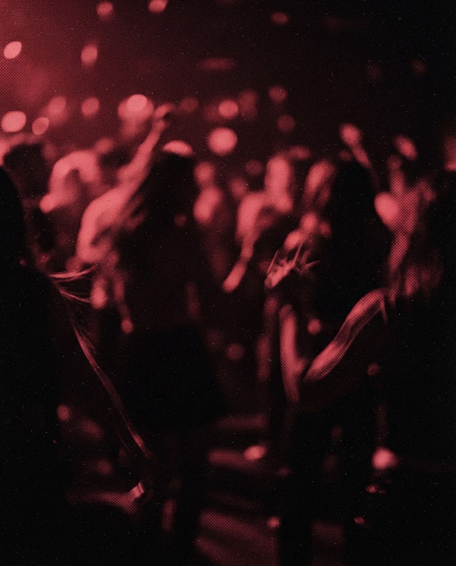 Silhouettes dancing, smeared by the long exposure under red light